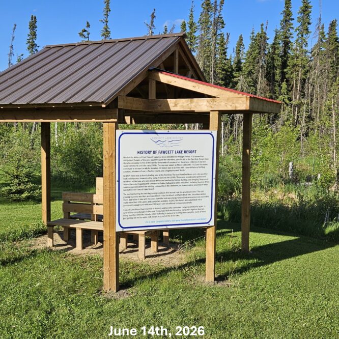 A wooden Gazebo with a sign titled "History of Fawcett Lake Resort" sits over green grass in front of trees under a blue sky. Text reads "June 14th, 2026" at the bottom.